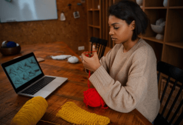 Person learning a creative skill through an online course on a laptop